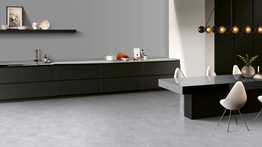 Modern kitchen with black cabinetry and gray floor tiles